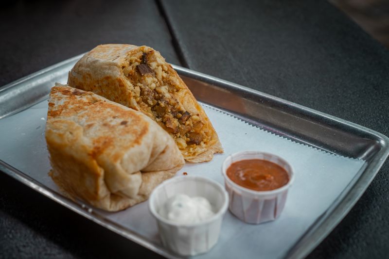 Chuys classic beef and bean burrito smothered in green sauce